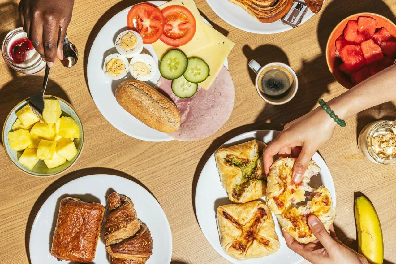 a table with plates of food on it at Point A Hotel Glasgow in Glasgow
