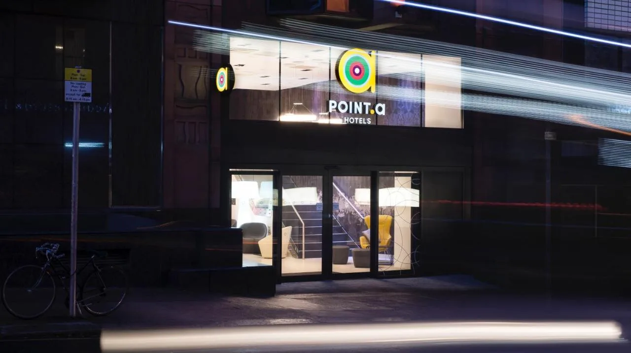 a view of a store front at night at Point A Hotel Glasgow in Glasgow