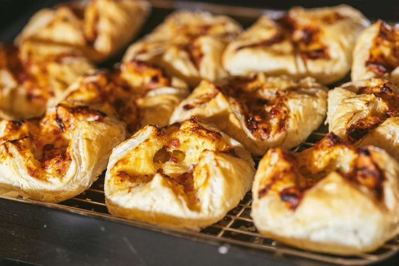 a bunch of small pastries on a cooling rack at Point A Hotel Glasgow in Glasgow